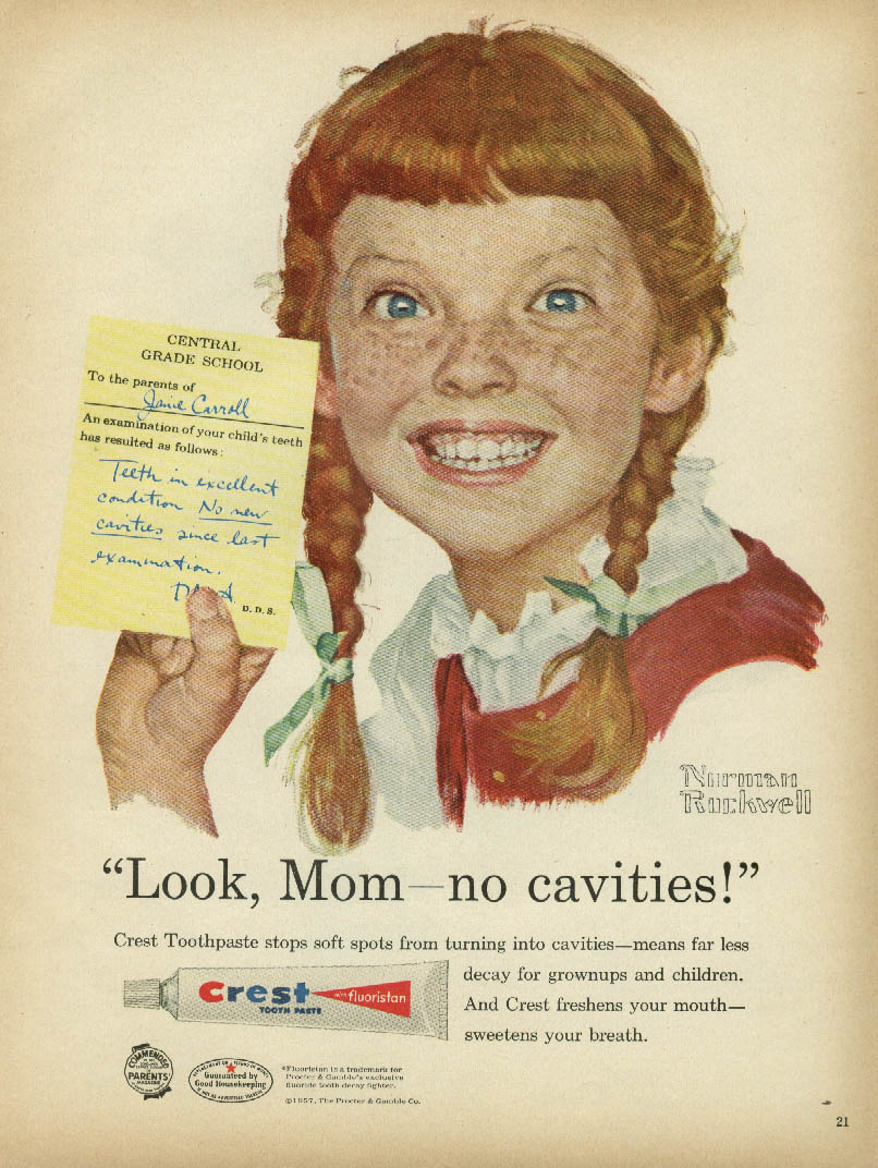 Redhead girl with freckles and pigtails showing a note from Central Grade School To the parents of Janie Carroll, An examination of your child's teeth has resulted as follows: Teeth in excellent condition No new cavities since last examination. Janie says 'Look Mom no new cavities' in this 1950s magazine ad from Crest and Norman Rockwell.