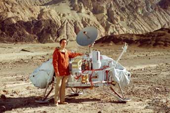 Carl Sagan with a model of NASA Viking Lander in desert Death Valley