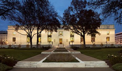 Picture of the National Academy of Sciences building lit up at night