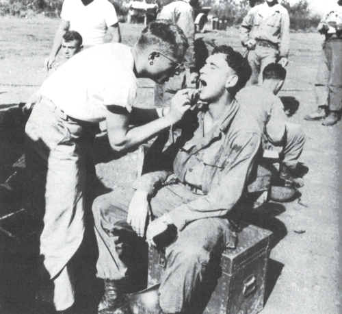 Picture of a dental exam being conducted in the field during World War 2