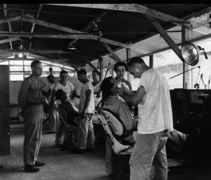 Dental exams in barracks-like building during World War 2